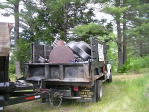 The Palmer Cleanouts & Disposal, LLC truck hauling away a load of junk