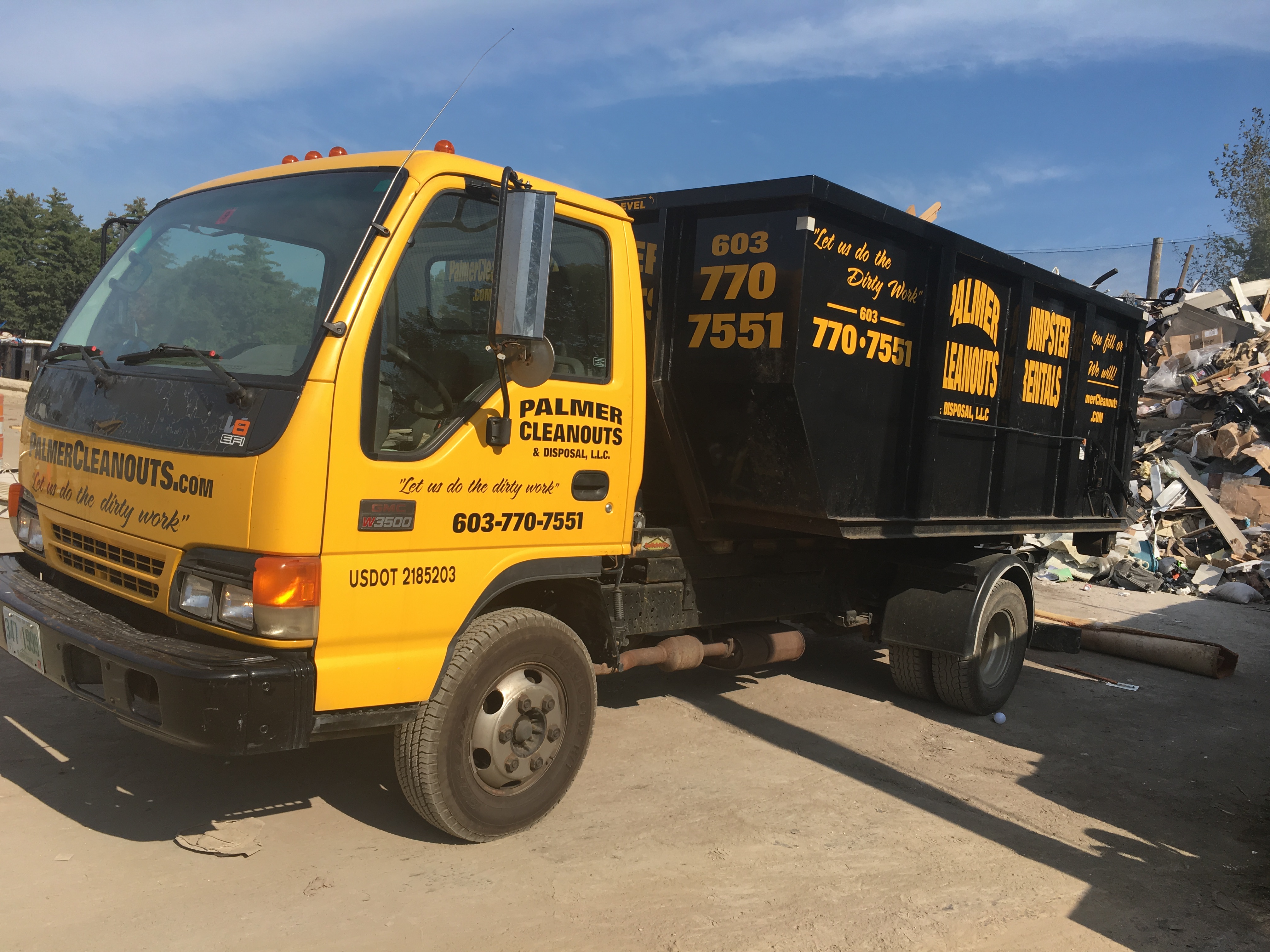 Yellow truck with Palmer Cleanouts logo on door